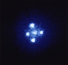  The ‘Einstein cross’ is actually four images of the same distant quasar that have been bent around a closer galaxy which acts like a gravitational lens. NASA, ESA, and STScI 
