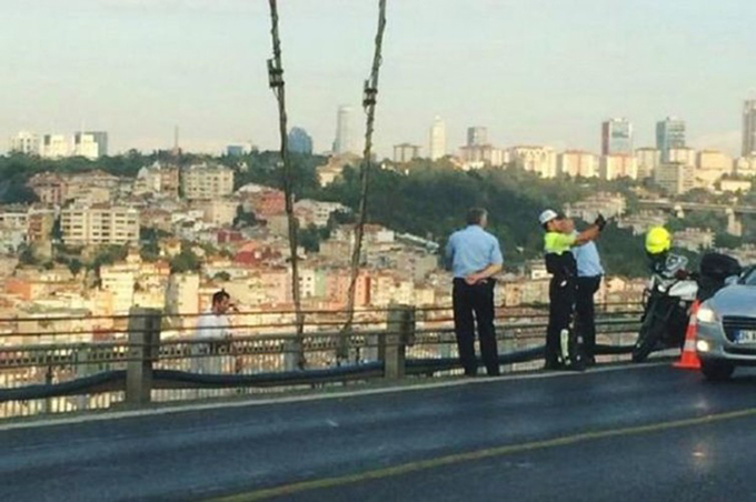 Image of a police officer taking a selfie with a man who jumps from a bridge in Ankara, Turkey in 2014.