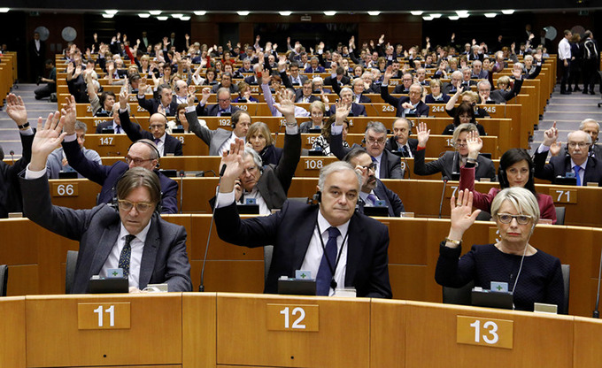 Hands up to support women’s participation in the EU parliament. Yves Herman/Reuters 